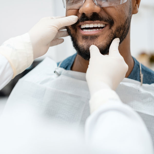 dentist examining man's smile
